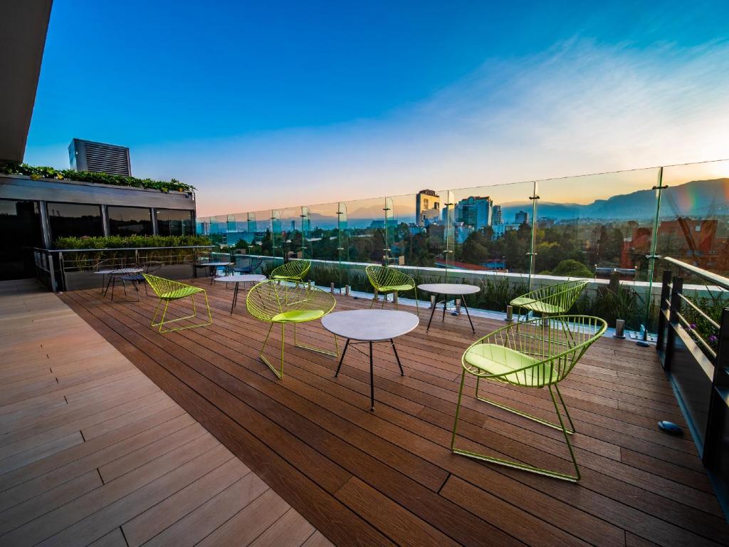 a group of chairs and tables on a balcony at Galeria Plaza San Jeronimo in Mexico City