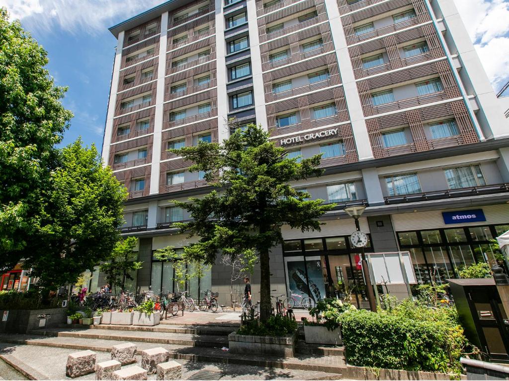 a tall building with a tree in front of it at Hotel Gracery Kyoto Sanjo in Kyoto