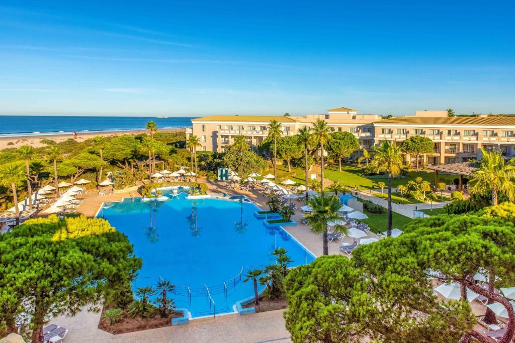 an aerial view of a resort with a swimming pool and the beach at Valentin Sancti Petri in Chiclana de la Frontera