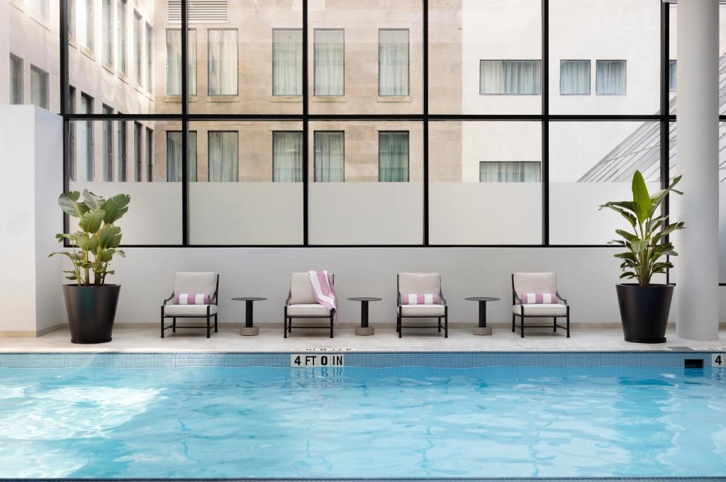 a group of chairs sitting next to a swimming pool at The Langham, Boston in Boston