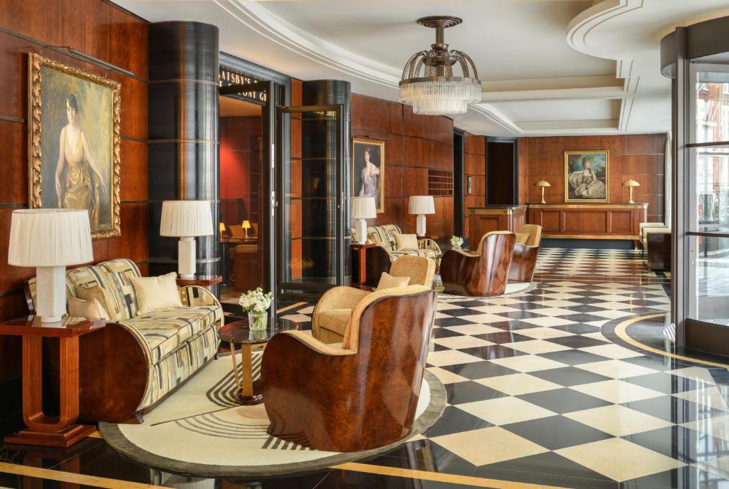 a lobby with couches and a checkered floor at The Beaumont Mayfair in London