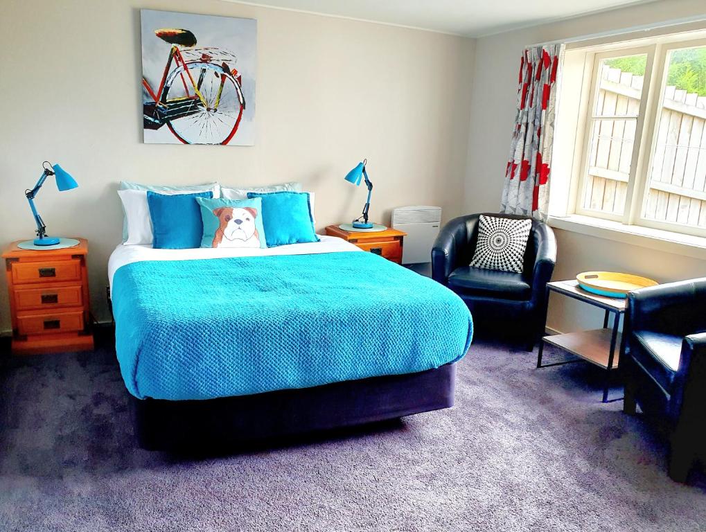 a bedroom with a bed and a bicycle on the wall at Travel Stay City Hostel in Dunedin