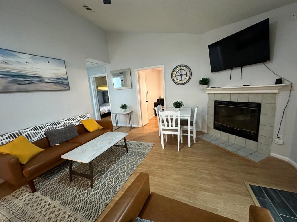 a living room with a couch and a fireplace at Beautiful House Sleeps 12 - Hot Tub - Breakfast - Walk to Beach in Panama City Beach