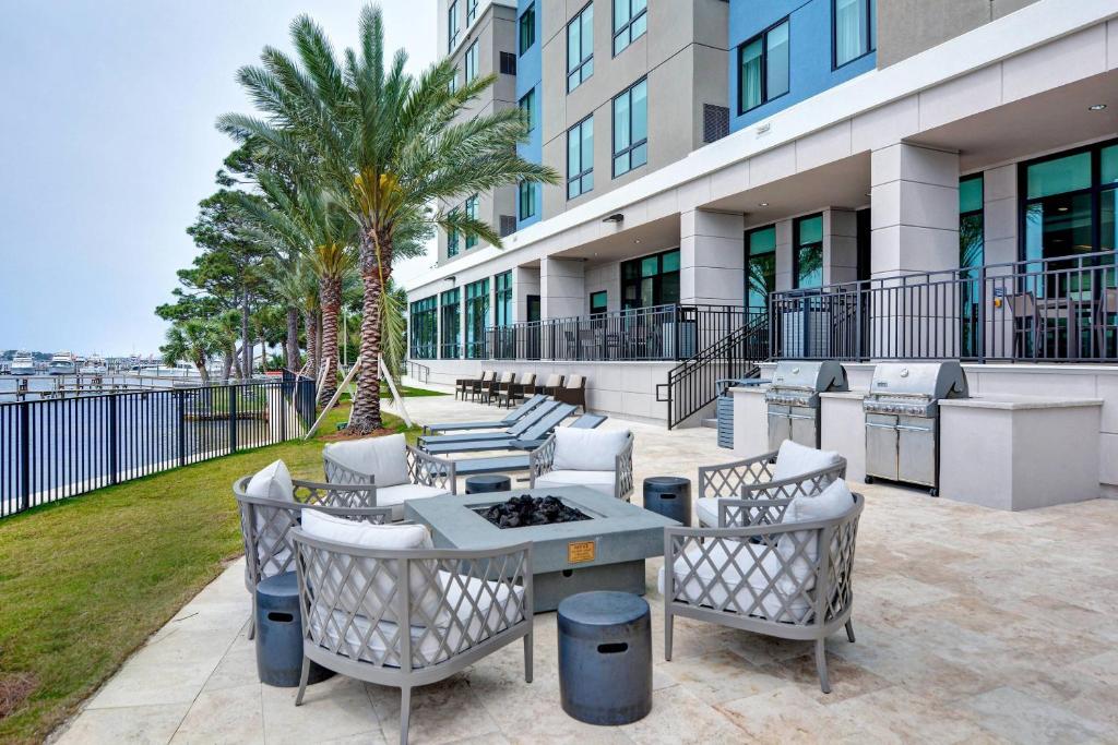 a patio with chairs and tables in front of a building at Residence Inn by Marriott Fort Walton Beach in Fort Walton Beach