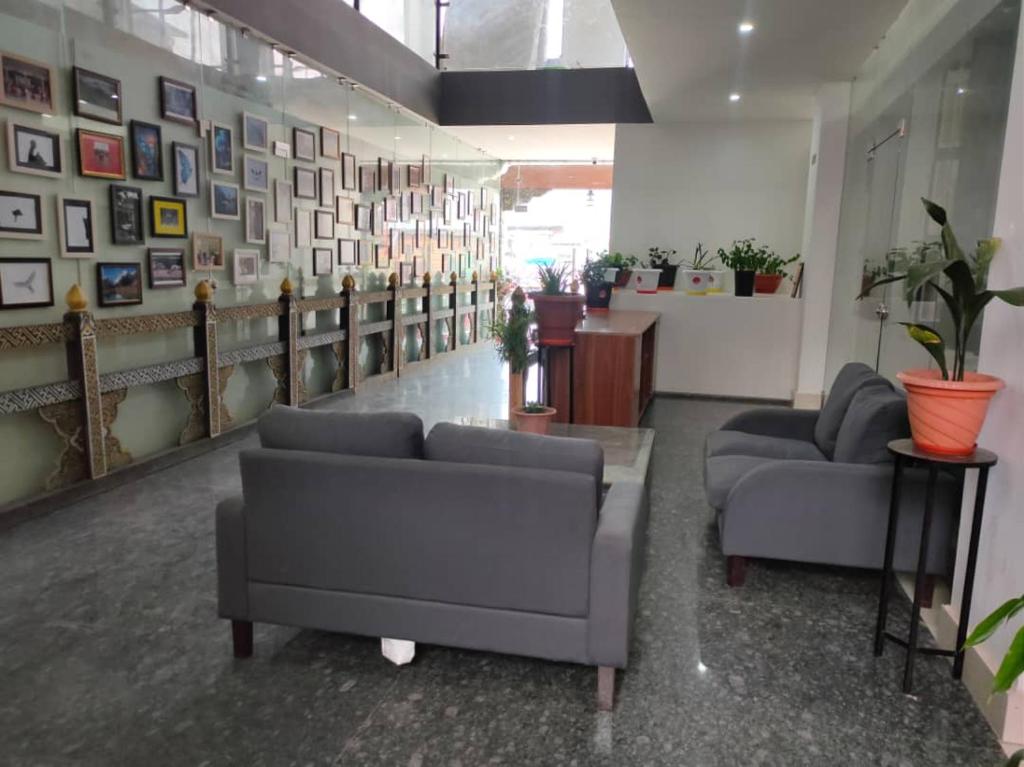 a waiting room with couches and pictures on the wall at Yang Bhutan Hotel in Paro