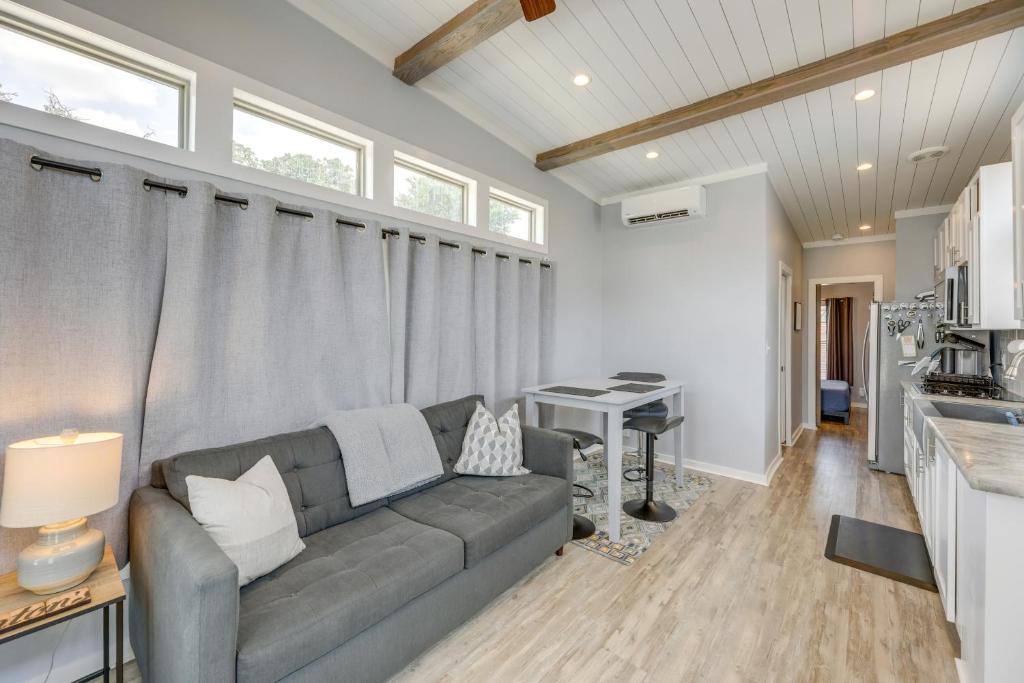 a living room with a couch and a desk at Community Pool and Hot Tub Austin Tiny Home! in Austin