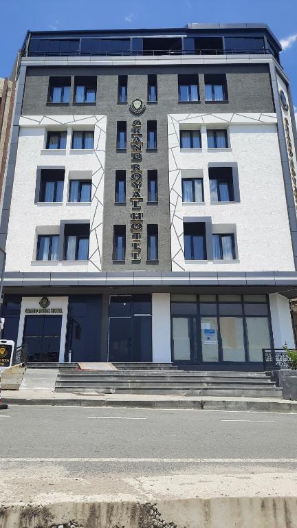 a building with a clock on the front of it at Grand royal hotel in Gümüşyaka