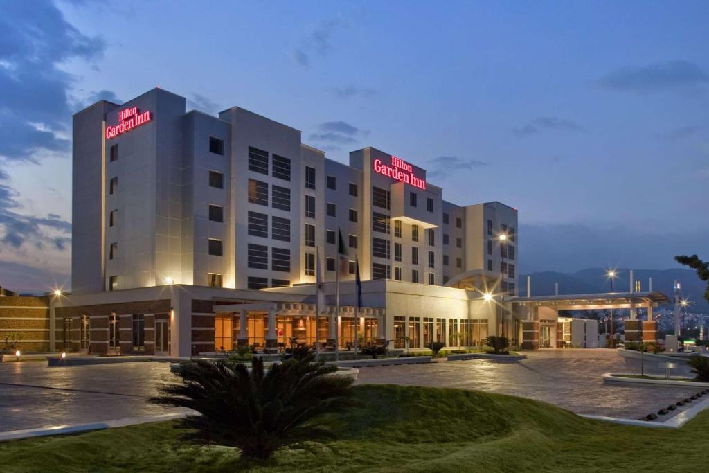 a hotel building with a lit up sign on it at Hilton Garden Inn Tuxtla Gutierrez in Tuxtla Gutiérrez