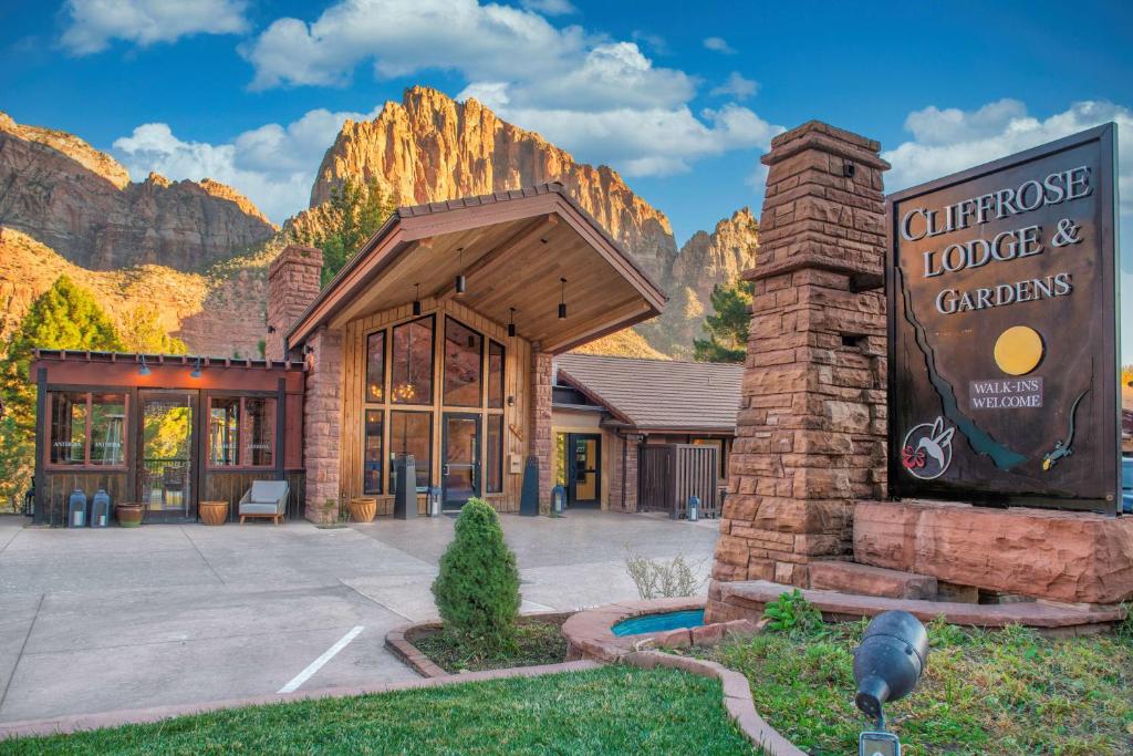 a building with a sign in front of a mountain at Cliffrose Springdale, Curio Collection By Hilton in Springdale