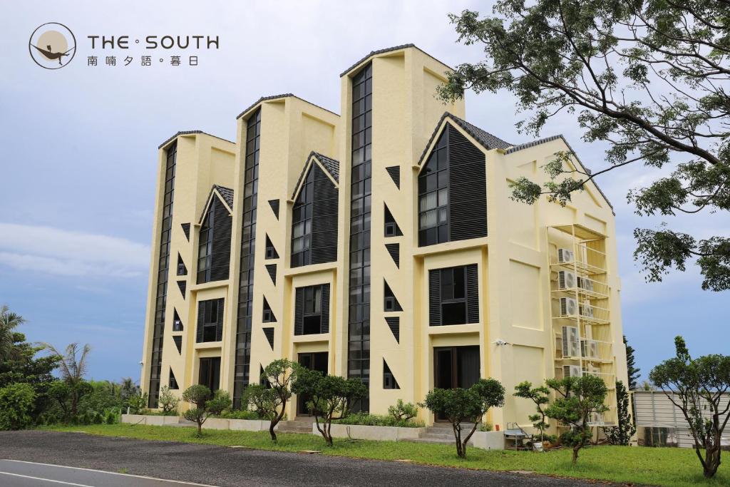 a large building with black shutters on it at The South-Sunset in Hengchun South Gate