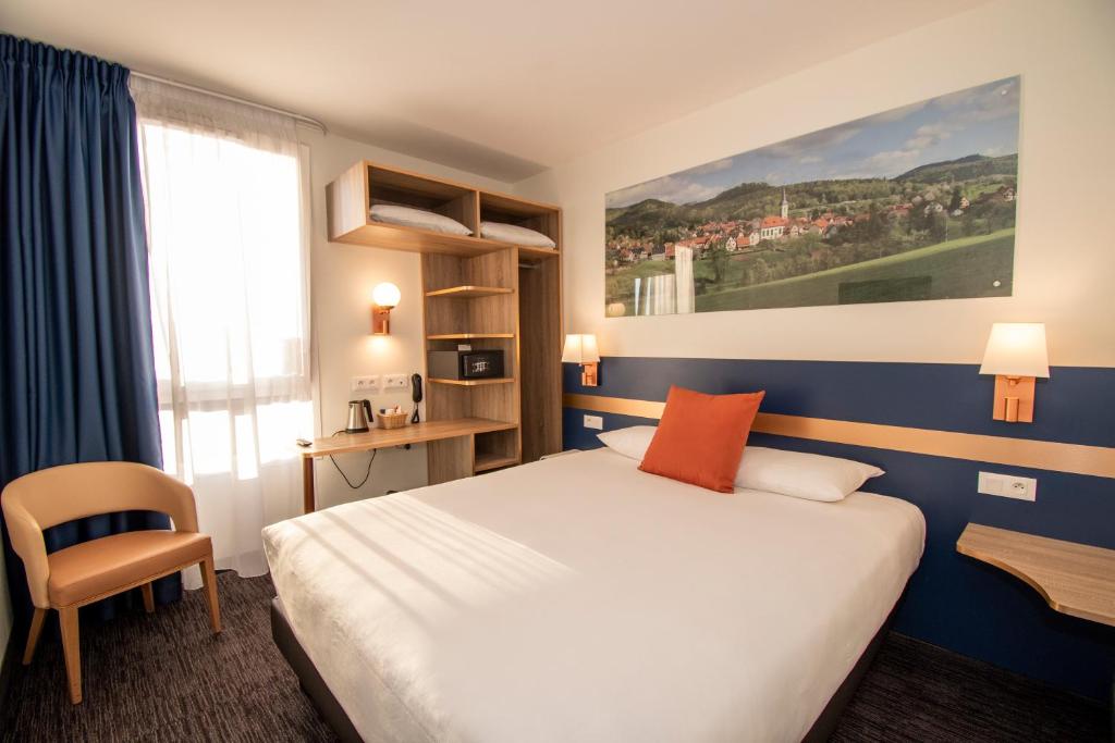 a hotel room with a large bed and a window at K Hotel in Strasbourg