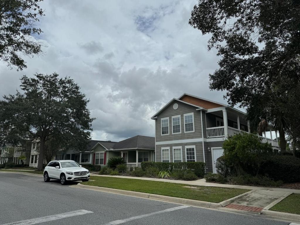 a white car parked in front of a house at A stylish and Comfy Place to Stay in Gainesville