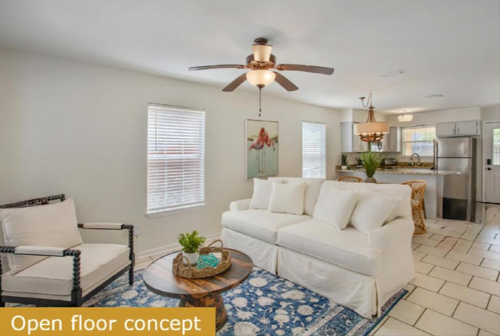 a living room with a white couch and a ceiling fan at Estrella del Mar in Panama City Beach