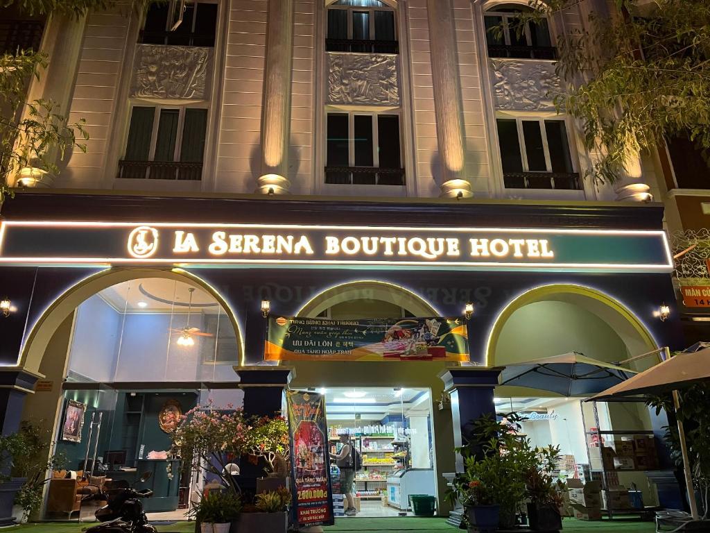 a building with a sign for a sirmania boutique hotel at La Serena Boutique Hotel in Ho Chi Minh City