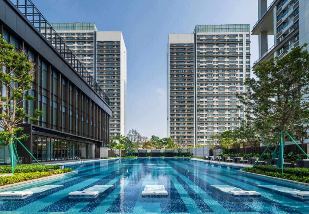 a swimming pool in a city with tall buildings at Hilton Shenzhen World Exhibition & Convention Center - Only 5 minutes' walk to WECC in Shenzhen