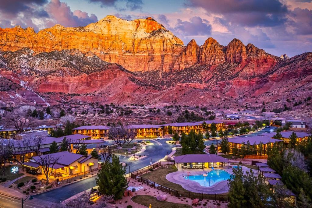 a view of a resort with mountains in the background at The Red Cliffs Lodge Zion, a Tribute Portfolio Hotel in Springdale