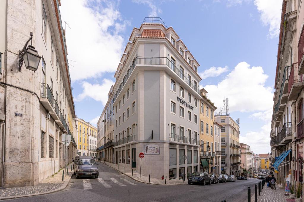 a tall white building on a city street at Westlight Lisboa Madalena in Lisbon