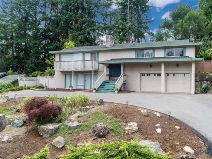 a large house with a garage and a driveway at GardenView queen-size bedroom in Redmond