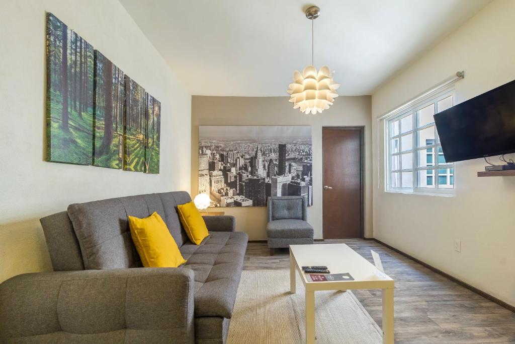 a living room with a couch and a table at OM 686 URBAN LOFTS Narvarte in Mexico City