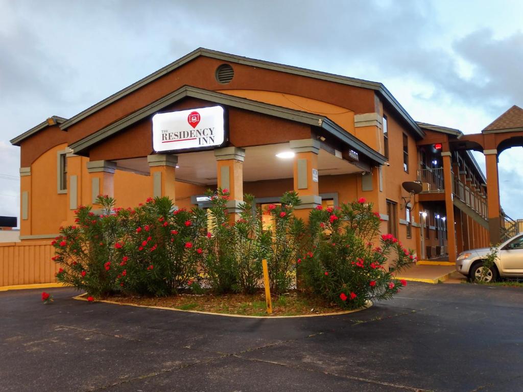 a hotel with flowers in front of a building at The Residency Inn in Galveston