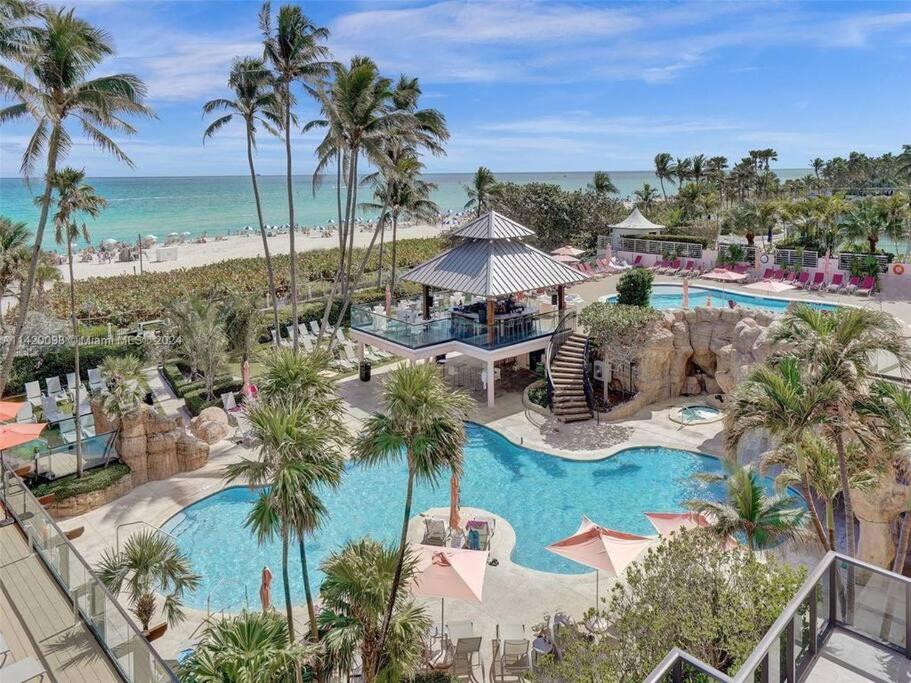 an aerial view of a resort with a swimming pool and the beach at 2 Bedrooms Unit OceanFront Resort The Alexander in Miami Beach