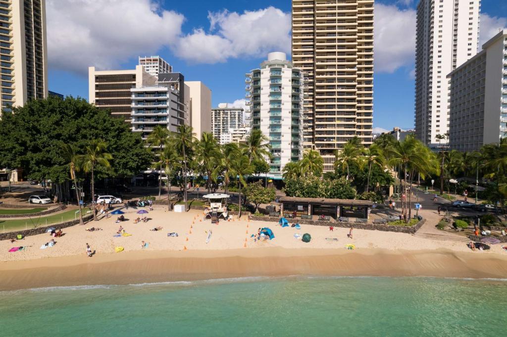 a beach in a city with people on it at Aston Waikiki Circle Hotel in Honolulu