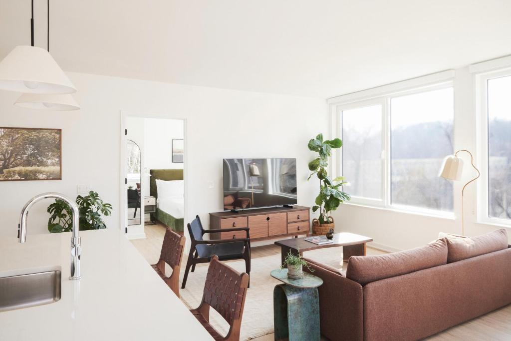 a living room with a couch and a tv at ROOST Kelly Drive in Philadelphia