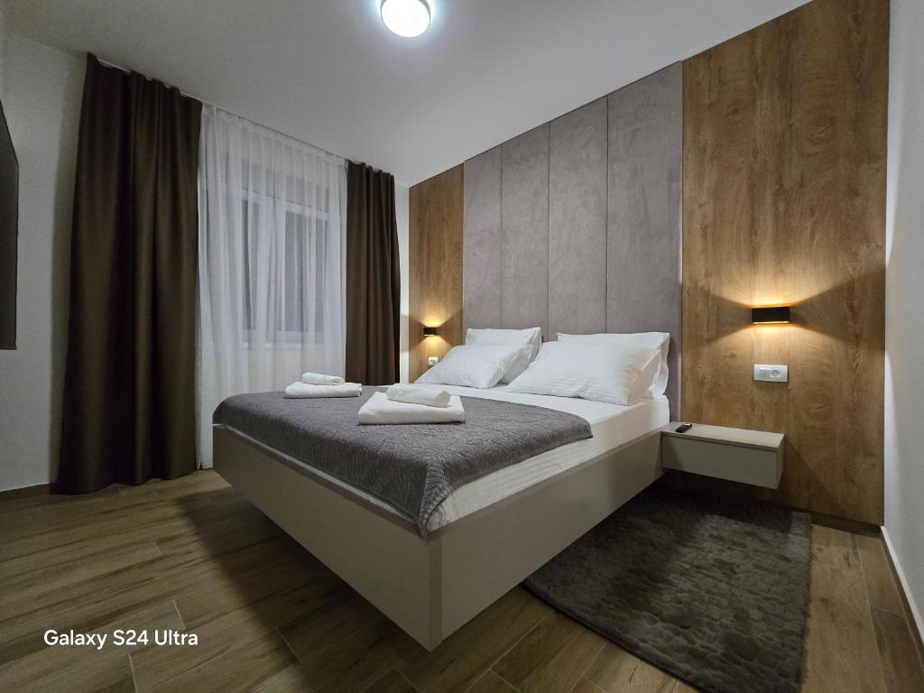 a bedroom with a large bed in a room at Apartman AURA self CHECK-IN, FREE PRIVATE PARKING in Osijek