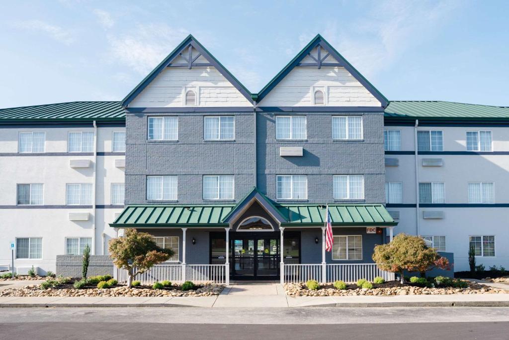 a large building with a flag in front of it at MainStay Suites Knoxville Airport in Alcoa