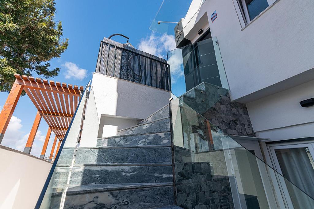 a stairway leading up to a white building with glass at MyPlaceLisbon - Lumiar Luxury House in Lisbon