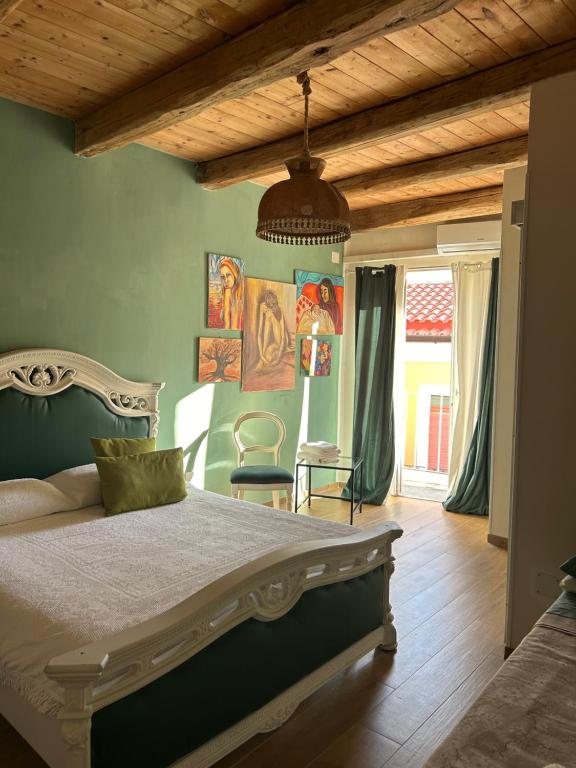 a bedroom with a large bed and a wooden ceiling at B&B Casa CamiLory in San Lucido