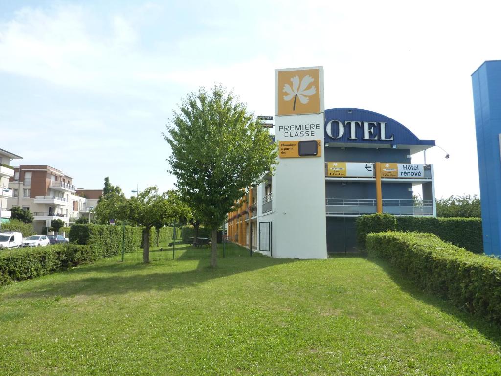 a building with a sign on the side of it at Premiere Classe Strasbourg Ouest in Strasbourg