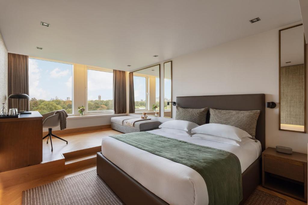 a large bedroom with a large bed and windows at Royal Garden Hotel in London