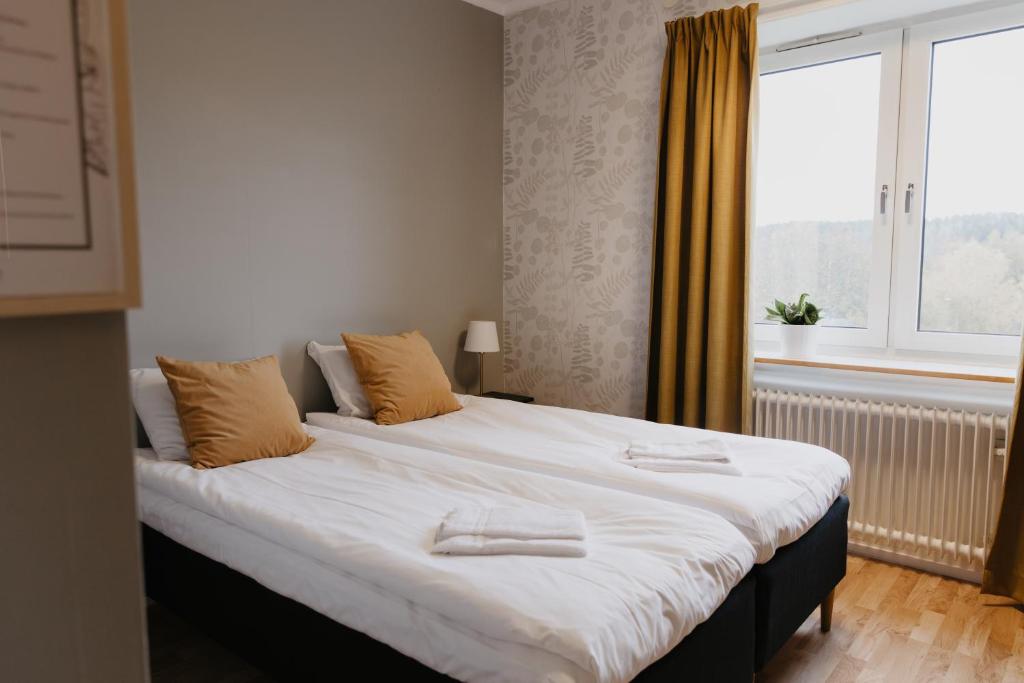 a large bed in a room with a window at Vassbo Vandrarhem in Falun