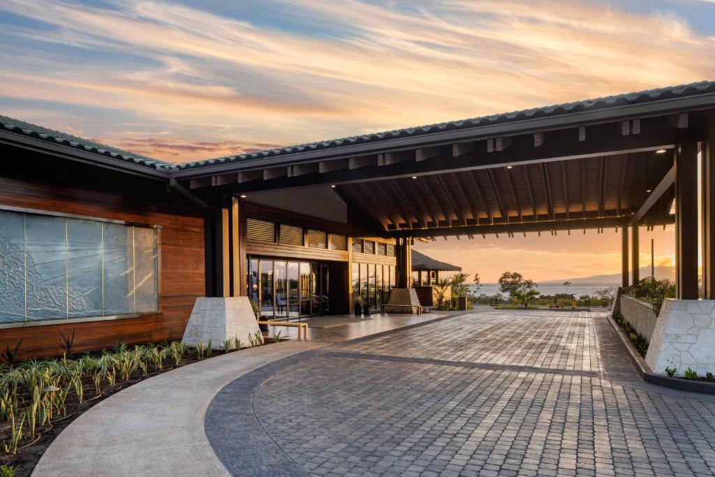 a rendering of a building with a sunset in the background at AC Hotel by Marriott Maui Wailea in Wailea