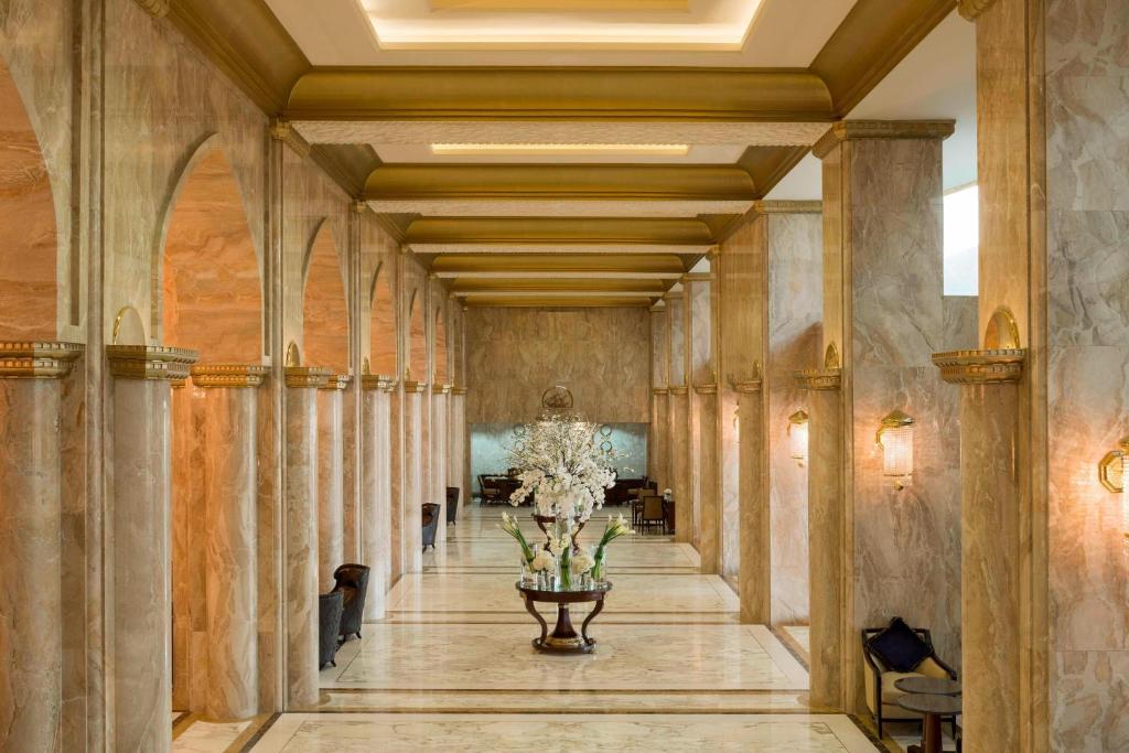 a hallway of a building with a vase of flowers at Sheraton Kuwait, a Luxury Collection Hotel, Kuwait City in Kuwait