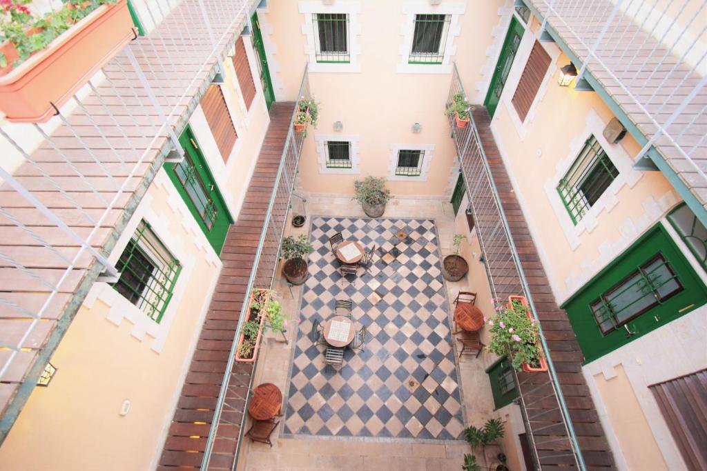 an overhead view of a courtyard of a building with potted plants at The Market Courtyard - Suites Hotel in Jerusalem