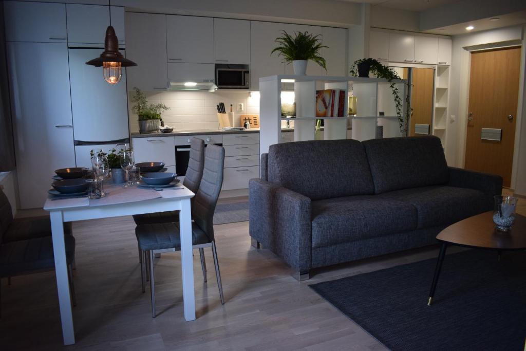 a living room with a couch and a table at DP Apartments Vaasa in Vaasa