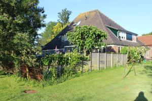 a house with a fence in a yard at Bed and Stay Amsterdam in Amsterdam