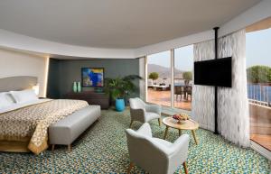 a hotel room with a bed and a television at Dan Eilat Hotel in Eilat