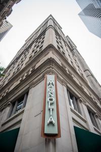 een gebouw met een bord ervoor bij Magnolia Hotel Downtown Dallas in Dallas