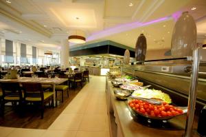 a restaurant with a buffet line with plates of food at U Magic Palace in Eilat