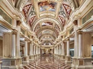 a hallway in a building with a ceiling with paintings at The Venetian® Resort Las Vegas in Las Vegas