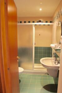 a bathroom with a shower and a sink and a toilet at Santanna in Verbania