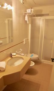 a bathroom with a sink and a toilet and a mirror at Santanna in Verbania