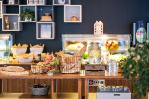 a bakery with a counter with food on it at Smarthotel Tromsø in Tromsø