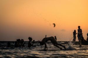 a group of people playing in the water at the beach at Palmed Hotel in Gizzeria