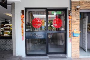 a door to a restaurant with red lanterns on it at Artisan Eco Hotel in Petaling Jaya