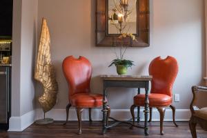 a room with two chairs and a table and a mirror at The Windsor - Asheville in Asheville