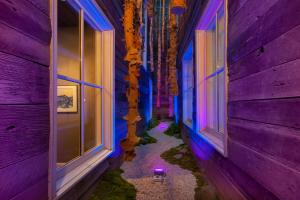 an alley with purple and blue walls and windows at The Windsor - Asheville in Asheville